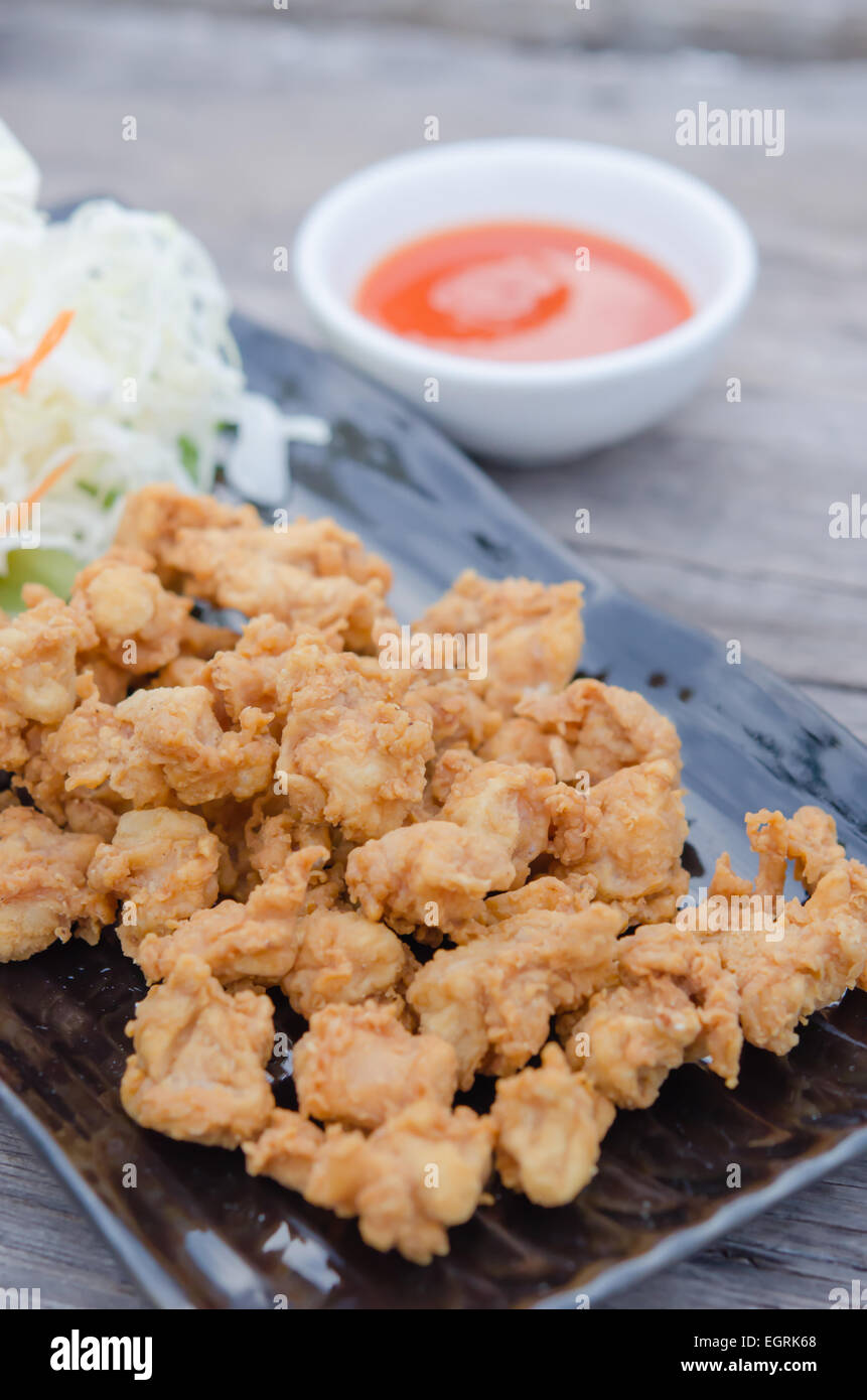 deep fried chicken tendons with fresh vegetable and chili sauce, asian
