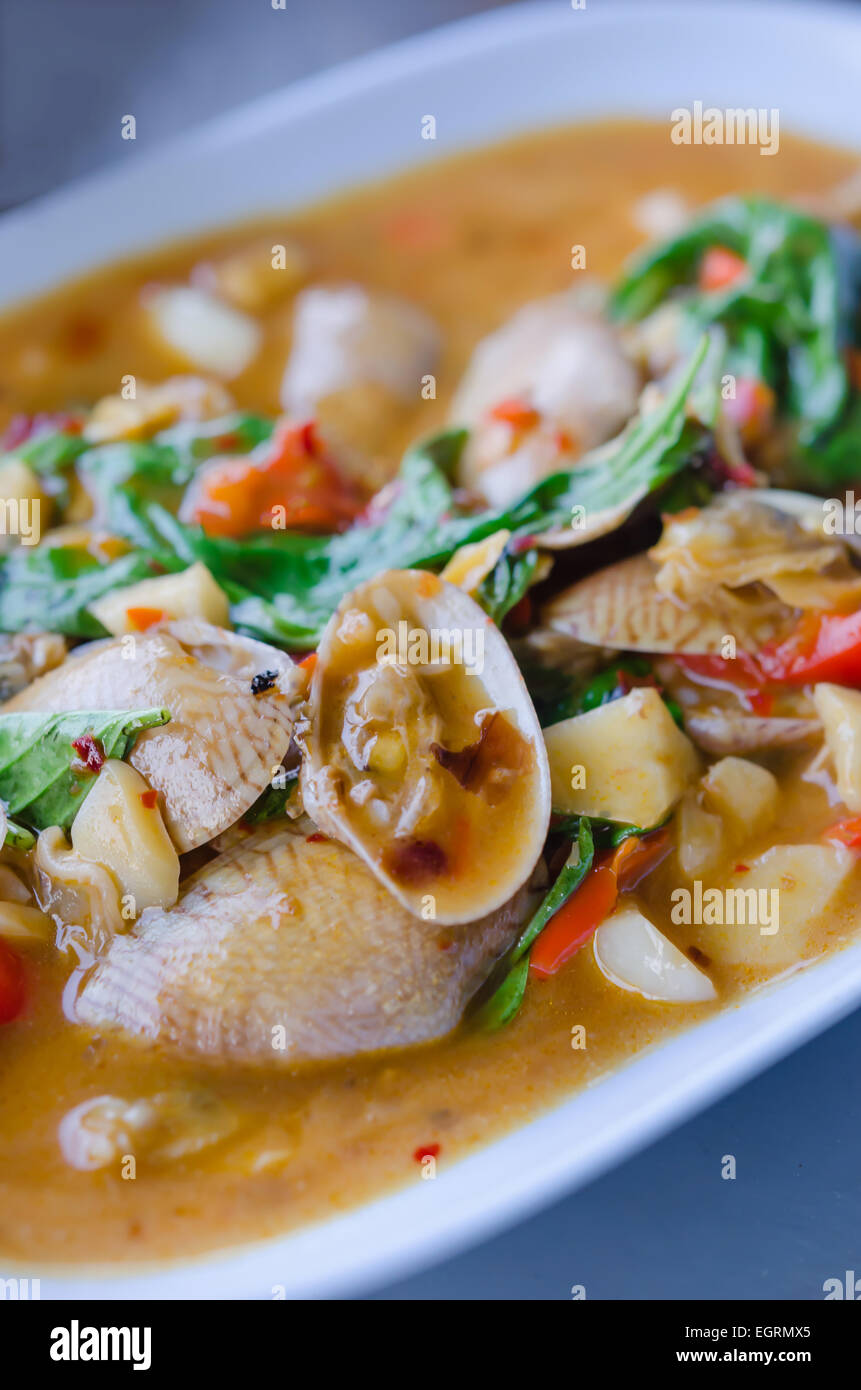 Stir fried clams with roasted chili paste and thai basil leaves Stock Photo