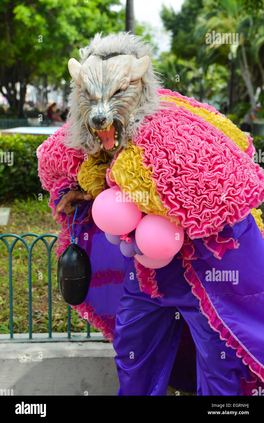 Pink and purple wolf masked Vejigante posing in the street of Ponce, Puerto Rico during the carnival 2015 Stock Photo