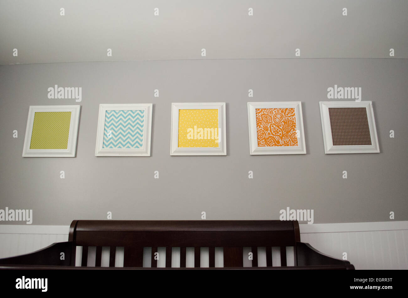 Pictures above baby's crib Stock Photo