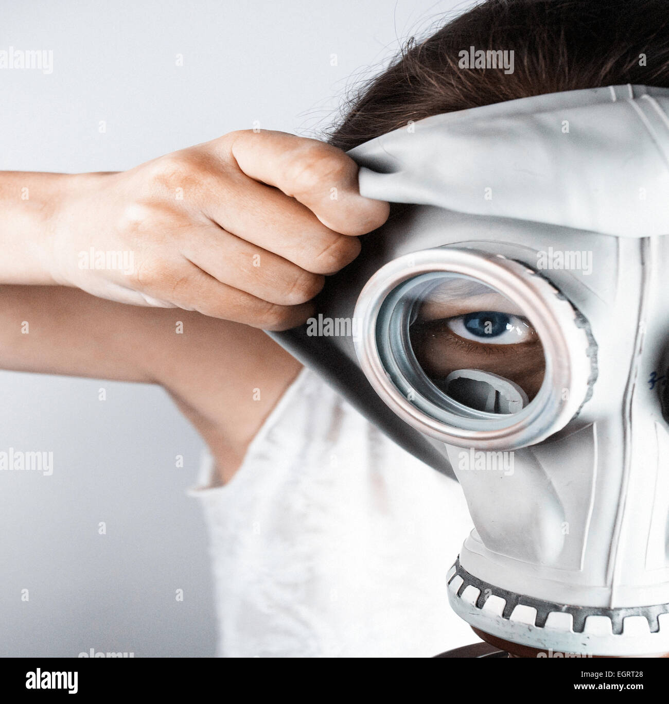 Closeup of woman putting on gas mask Stock Photo Alamy