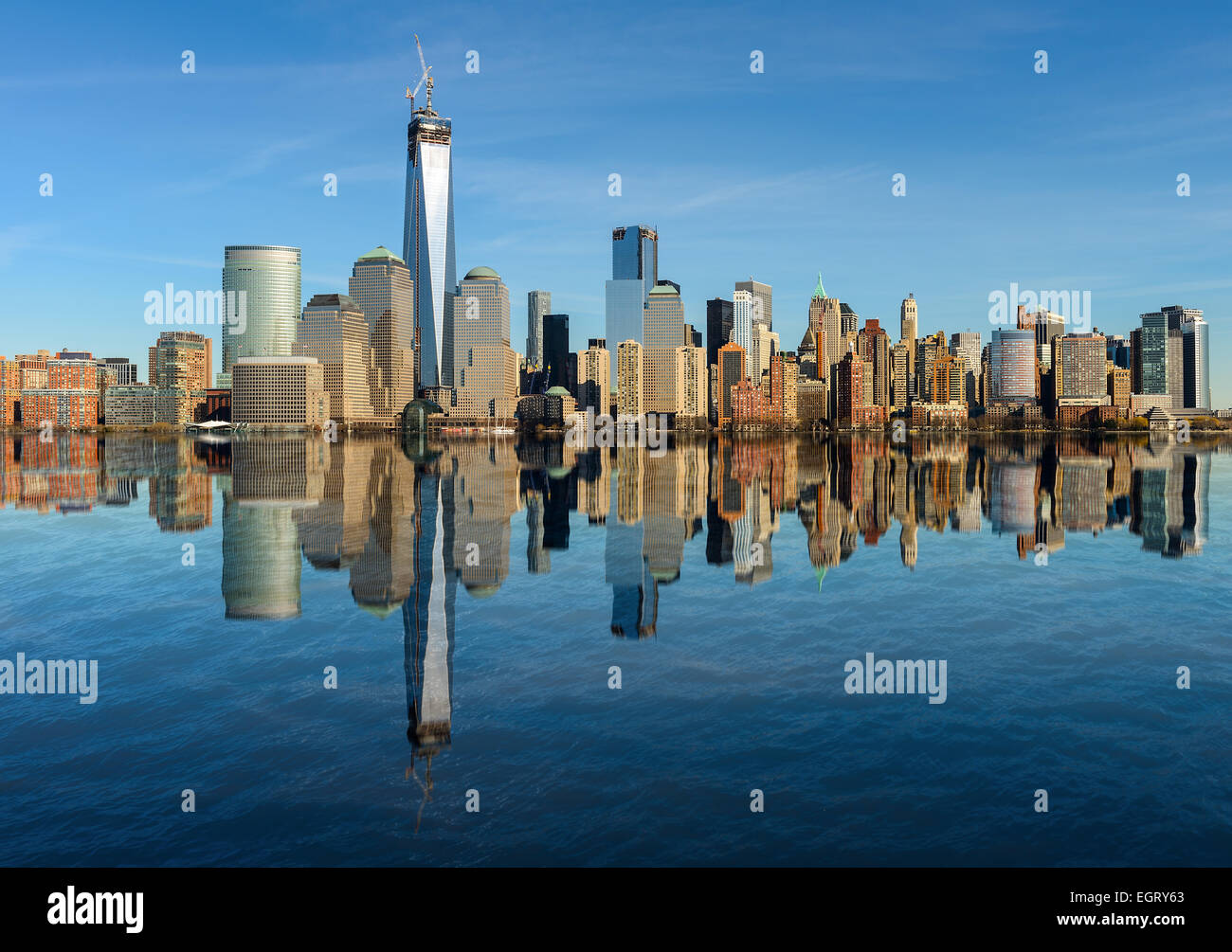 Lower Manhattan skyline panorama over East River with reflection and ...