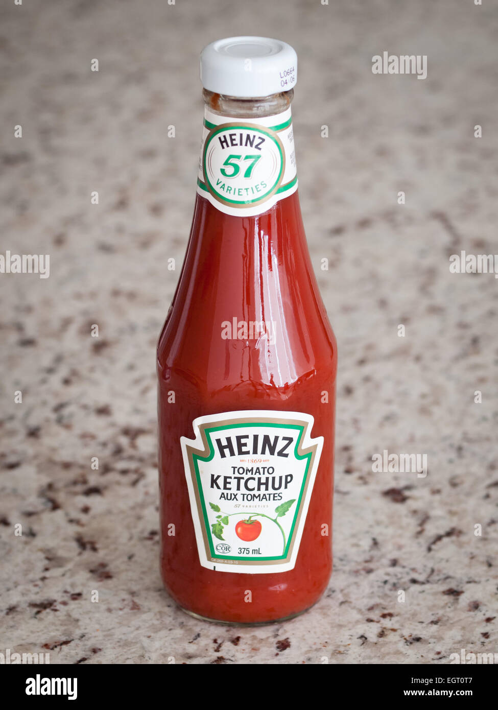 A classic, glass Heinz Tomato Ketchup bottle.  Canadian packaging shown. Stock Photo