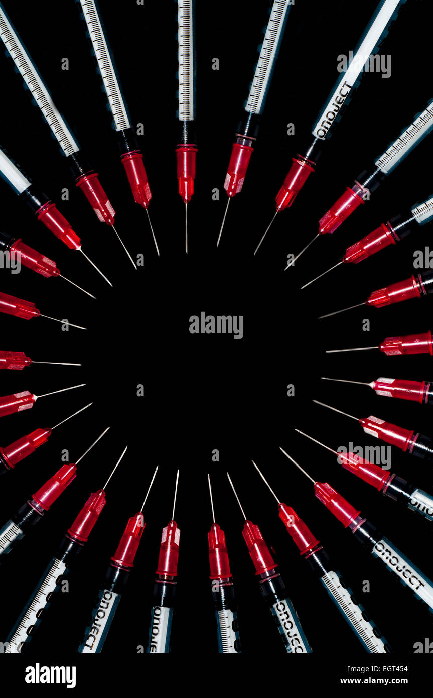 Used syringes arranged in a circle; concept shot for drug abuse Stock Photo