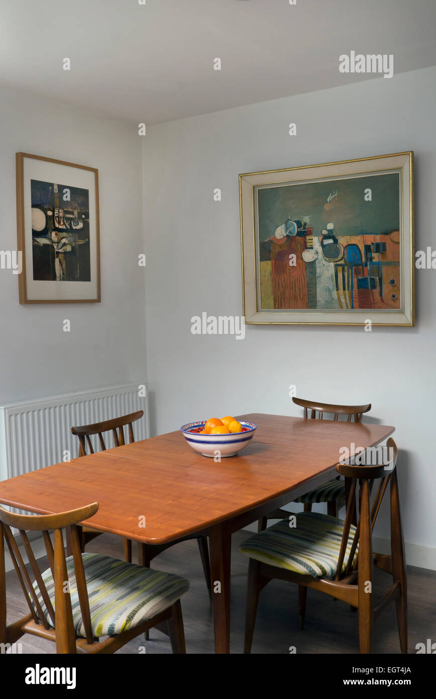 1960's dinning room with paintings on the wall Stock Photo