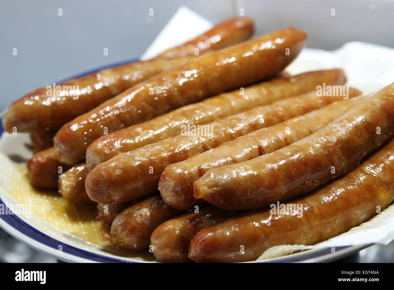 Close up of cooked sausages on a plate Stock Photo