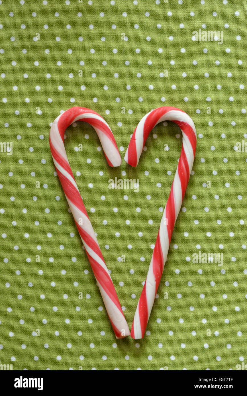Red and white candy canes forming heart shape Stock Photo