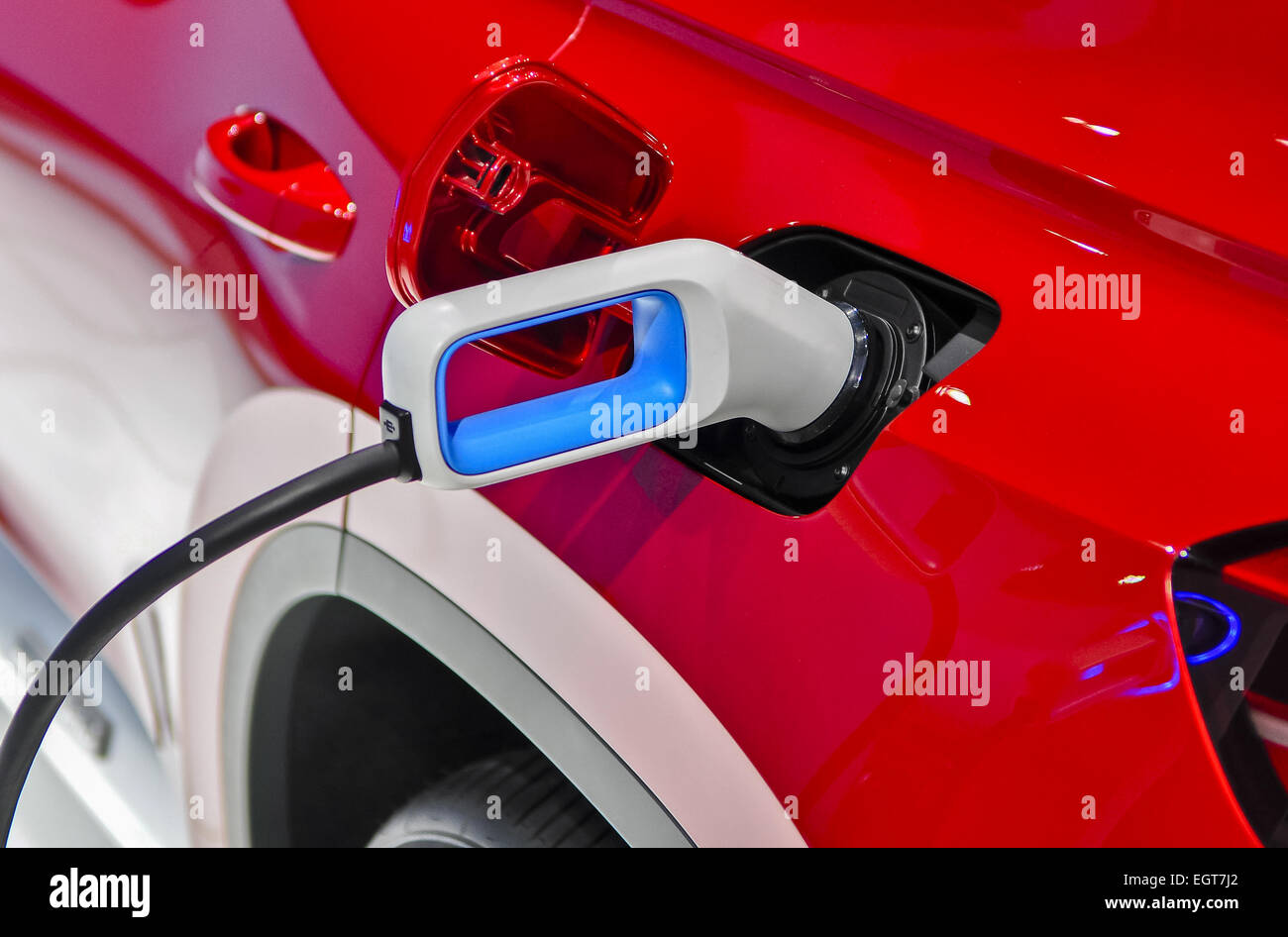 the electric vehicle charging cable inserted in plug Stock Photo