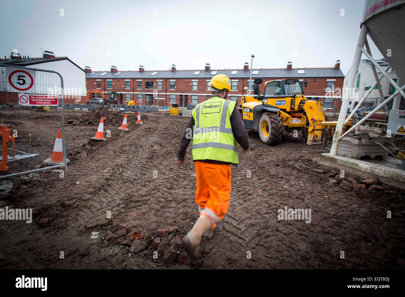 A worker from Rowlinson on a construction site in Moss Side Manchester Stock Photo