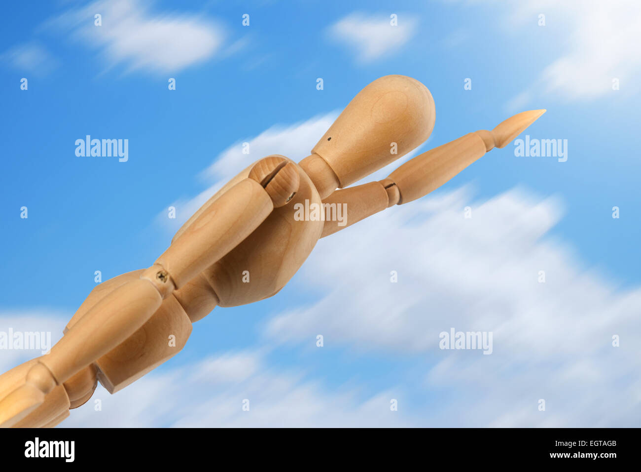 Dummy superhero in flight on blue sky with clouds. Stock Photo