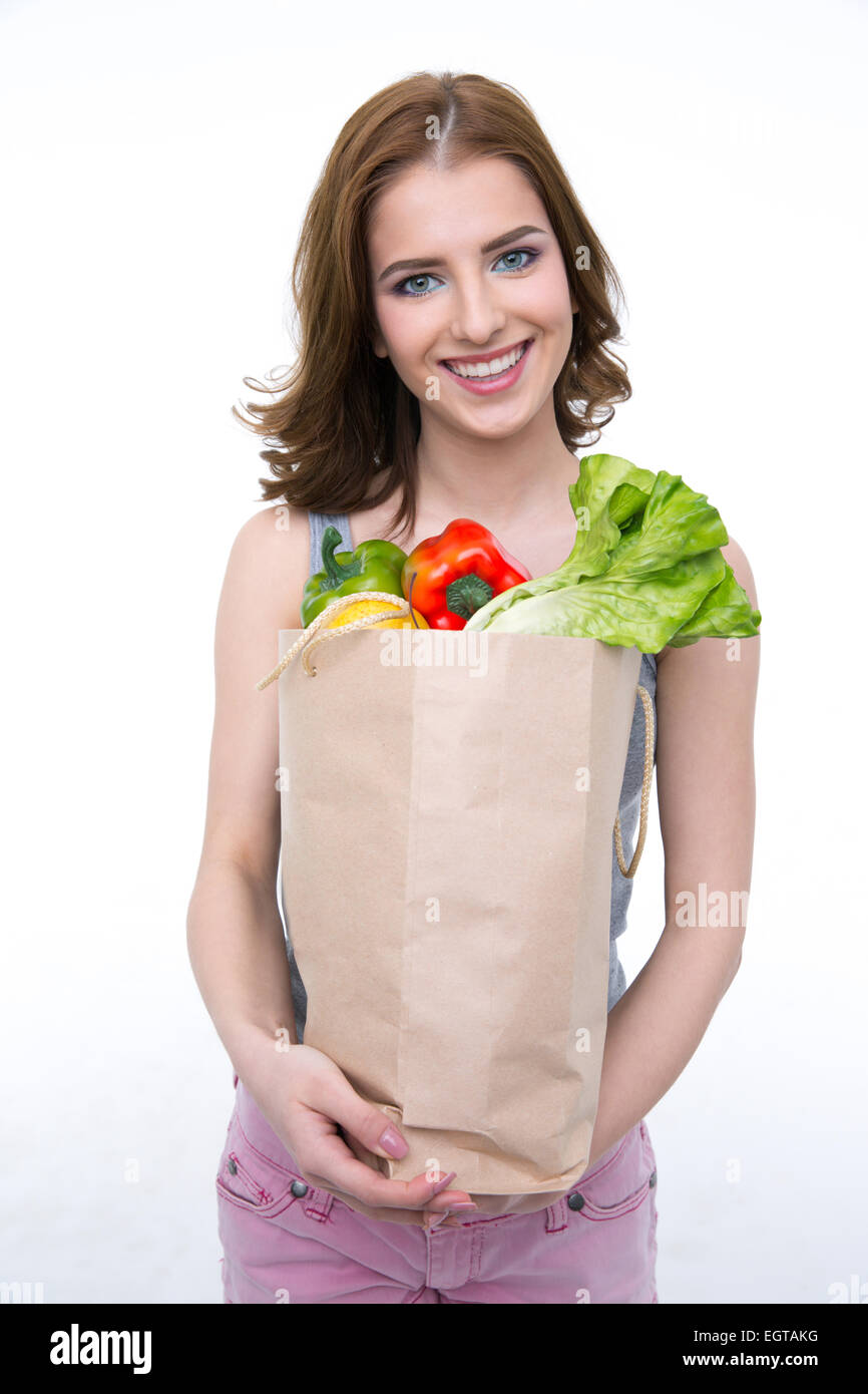 Happy cute woman holding a shopping bag full of groceries Stock Photo