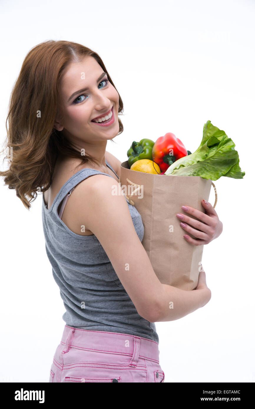 Happy beautiful woman holding a shopping bag full of groceries Stock Photo