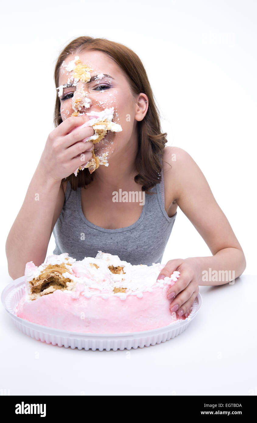 Overweight woman eating big cake. Young overweight woman eating big piece  of cake. | CanStock
