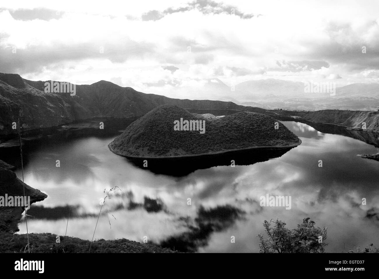 Clouds and islands reflected in the water of the volcanic crater lake, Lake Cuicocha, near Cotacachi, Ecuador Stock Photo