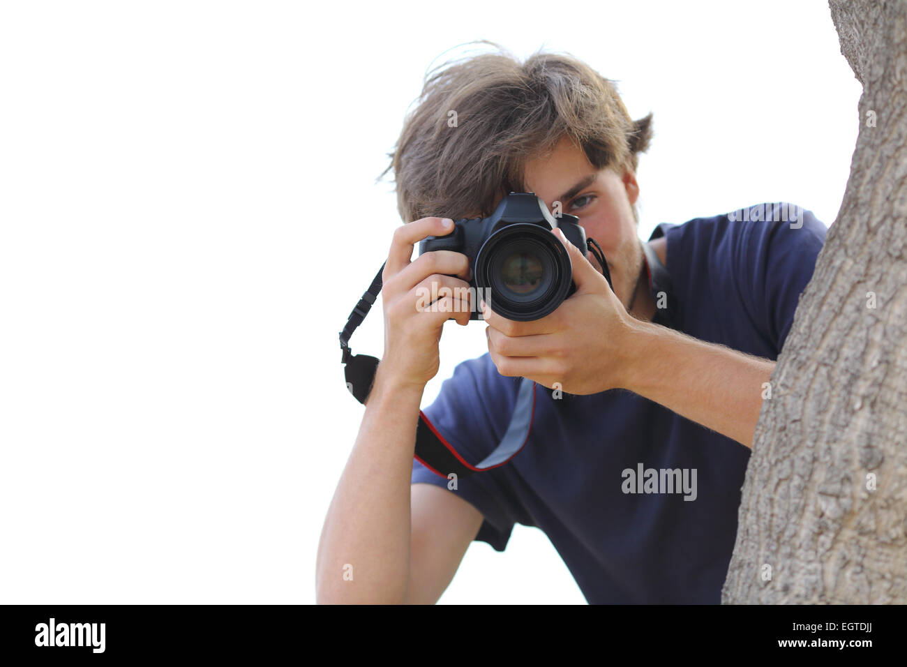 Paparazzi taking a photograph hidden on white isolated on a white background Stock Photo