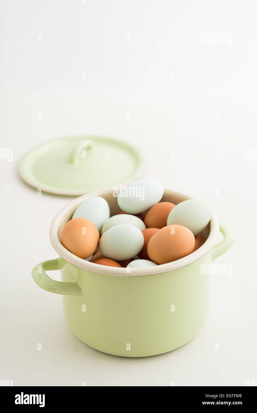 Fresh light green eggs from Easter egger chicken and brown eggs in a