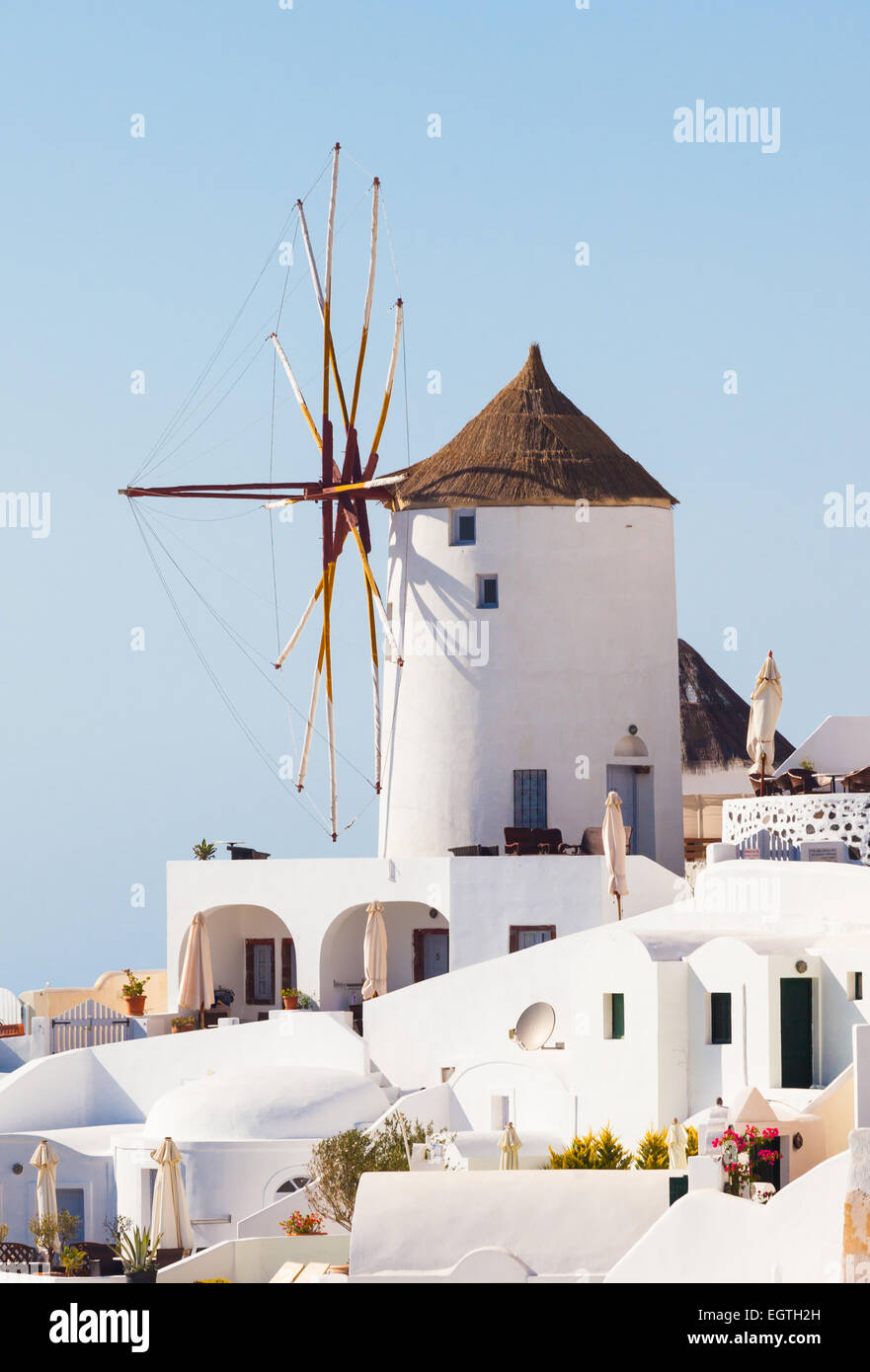 Windmill in Oia, Santorini. Oia is a village in the north west edge of the Santorini island with white houses. Stock Photo