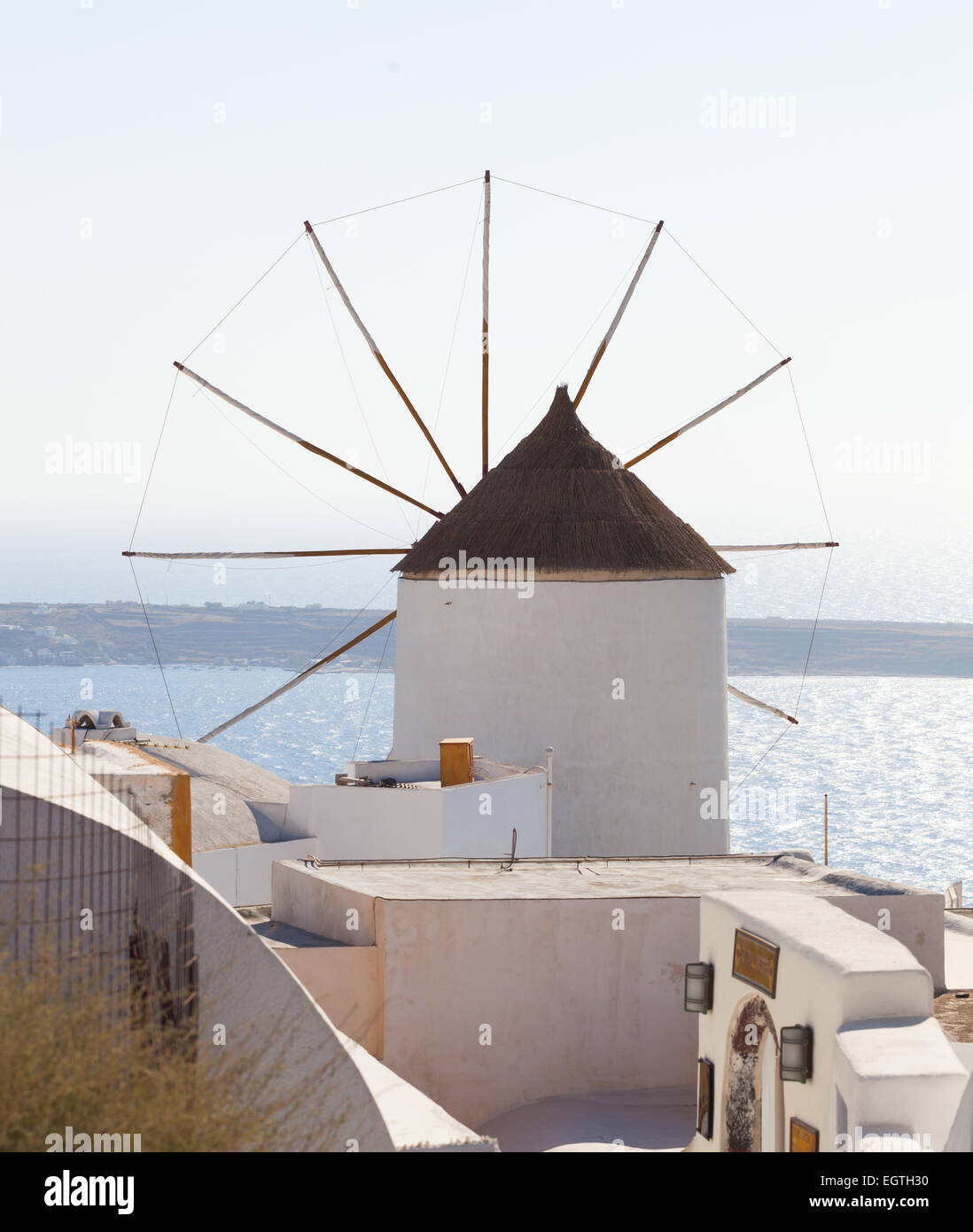 Windmill in Oia, Santorini. Oia is a village in the north west edge of the Santorini island with white houses. Stock Photo