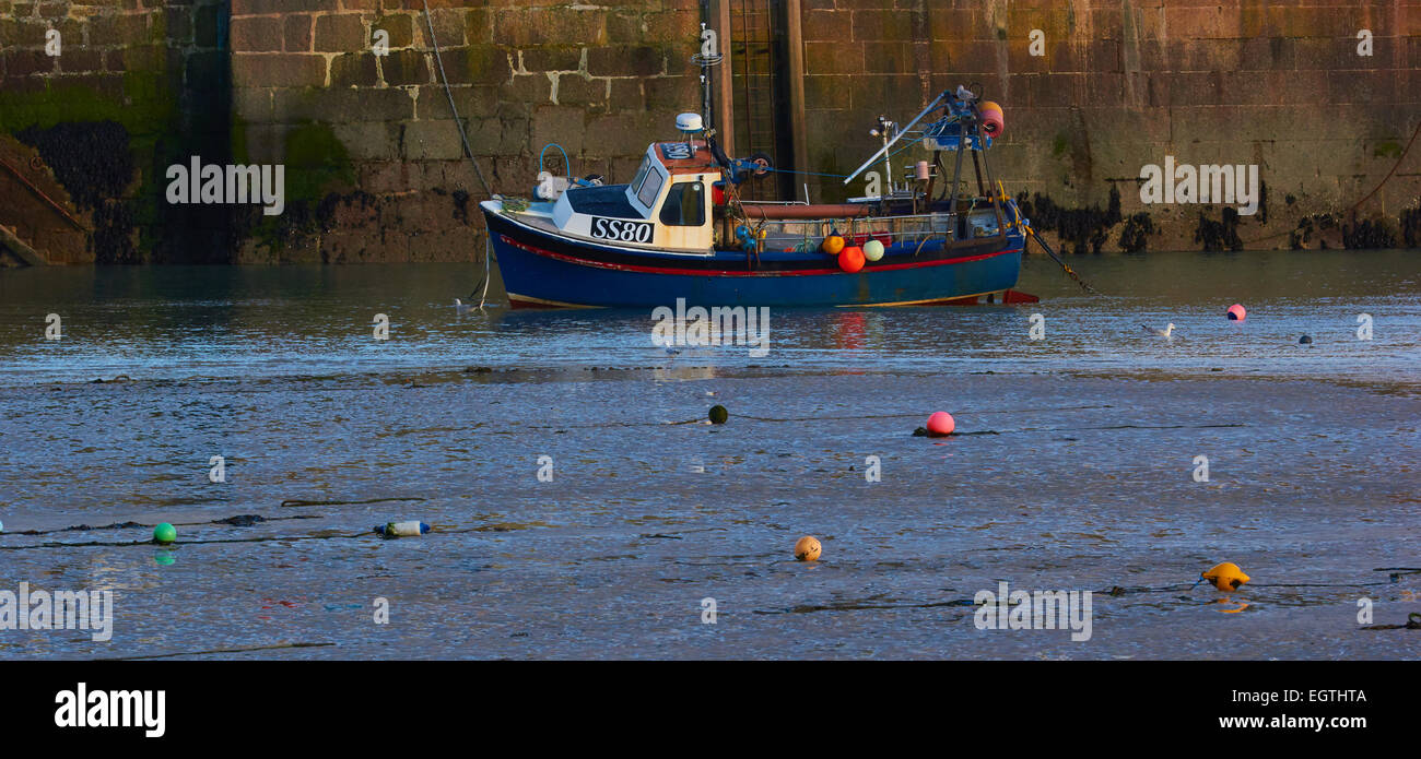 Fishing boat and colourful buoys in St Ives harbour at low tide Cornwall England Europe Stock Photo