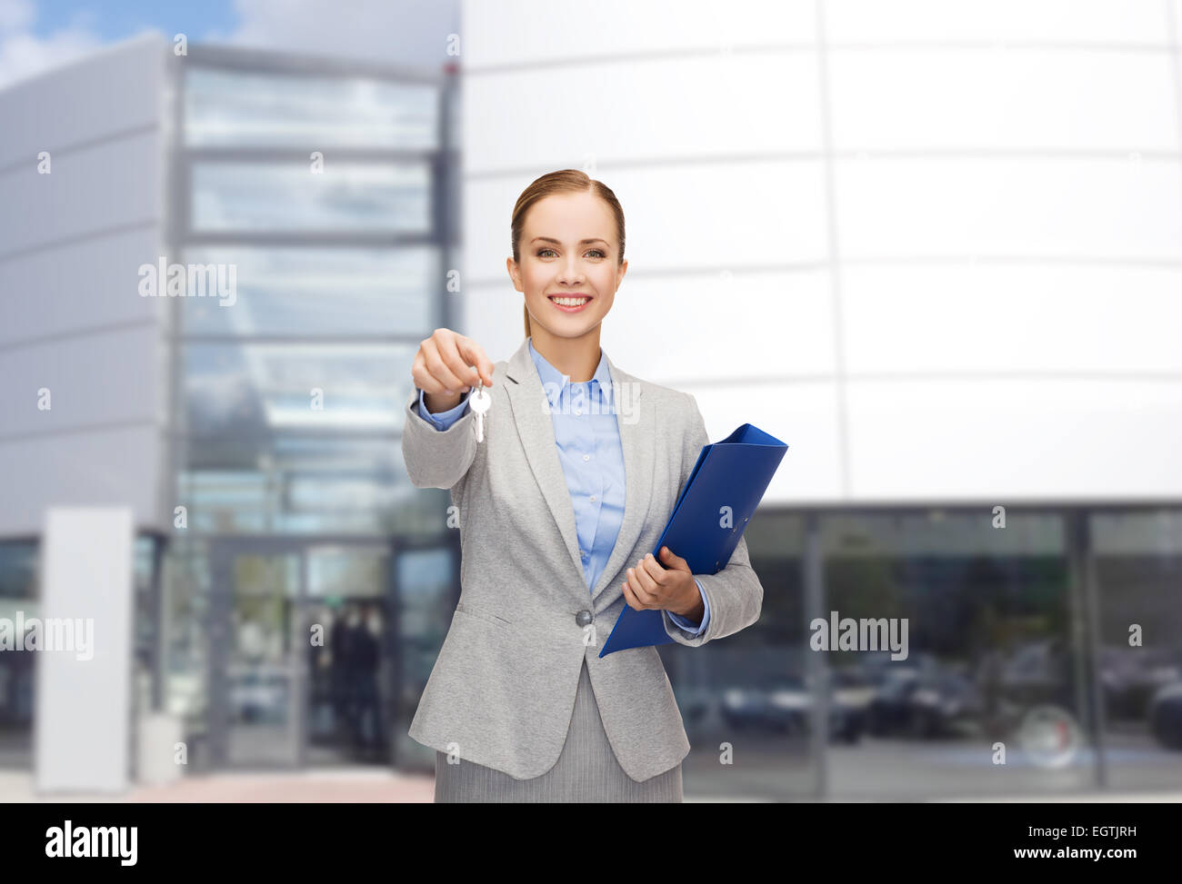 smiling businesswoman with folder and keys Stock Photo - Alamy