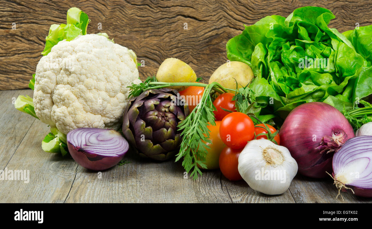 mix of fresh raw vegetables on old wooden table Stock Photo