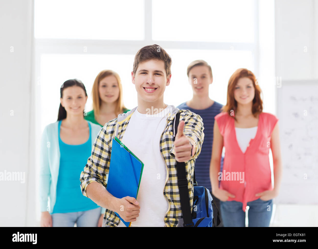 male student with classmates showing thumbs up Stock Photo - Alamy