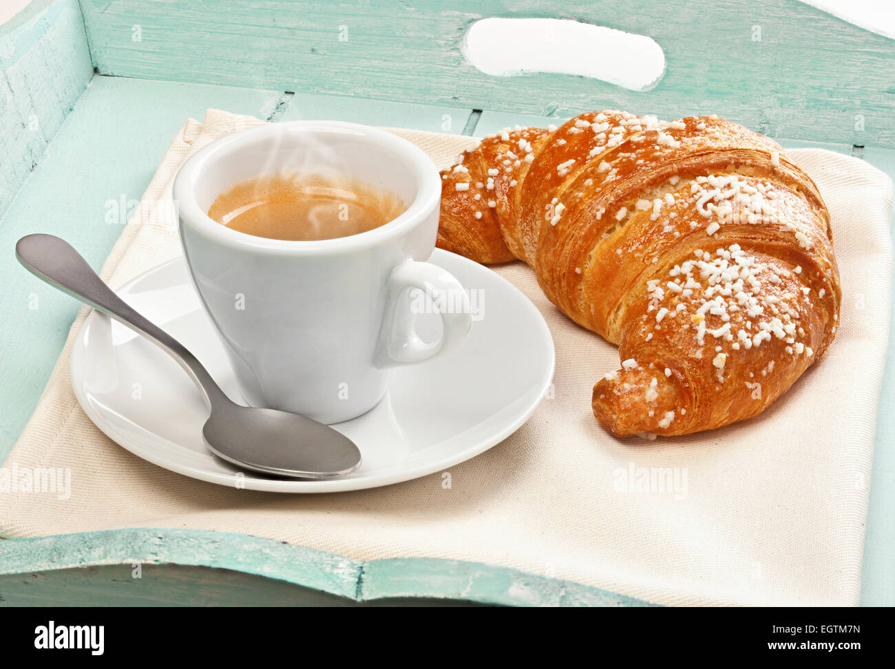 Espresso coffee with croissant in wooden tray light blue. Stock Photo