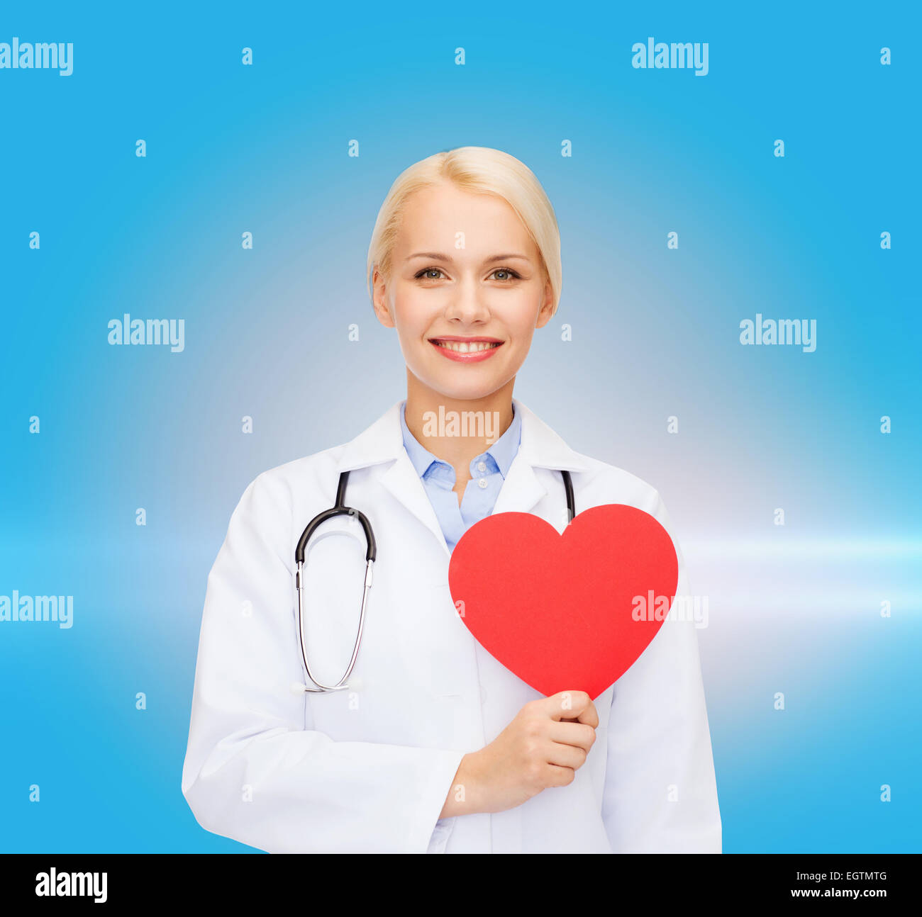 smiling female doctor with heart and stethoscope Stock Photo - Alamy