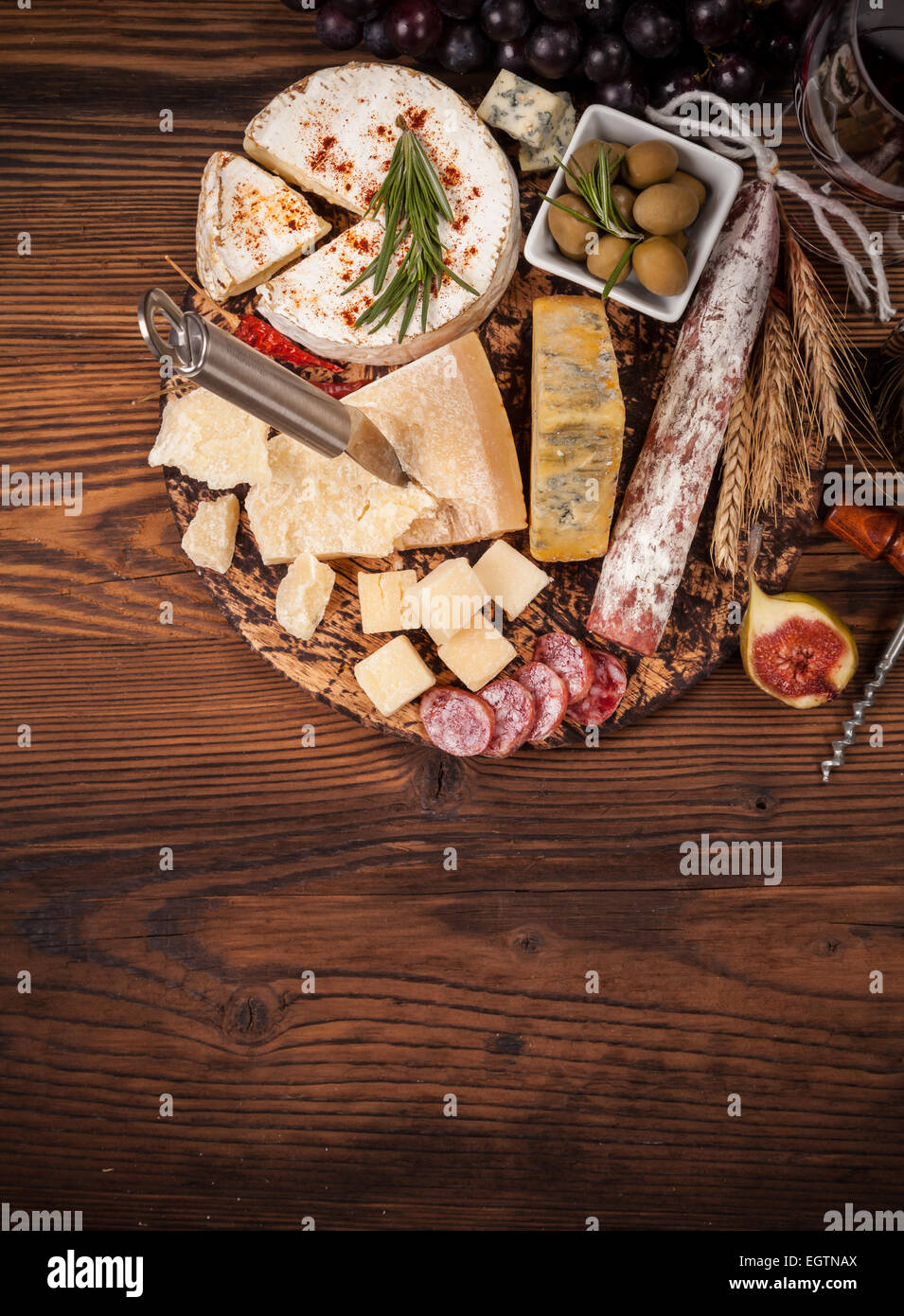 Cheese arrangement served on cutting board. Shot from aerial view Stock Photo