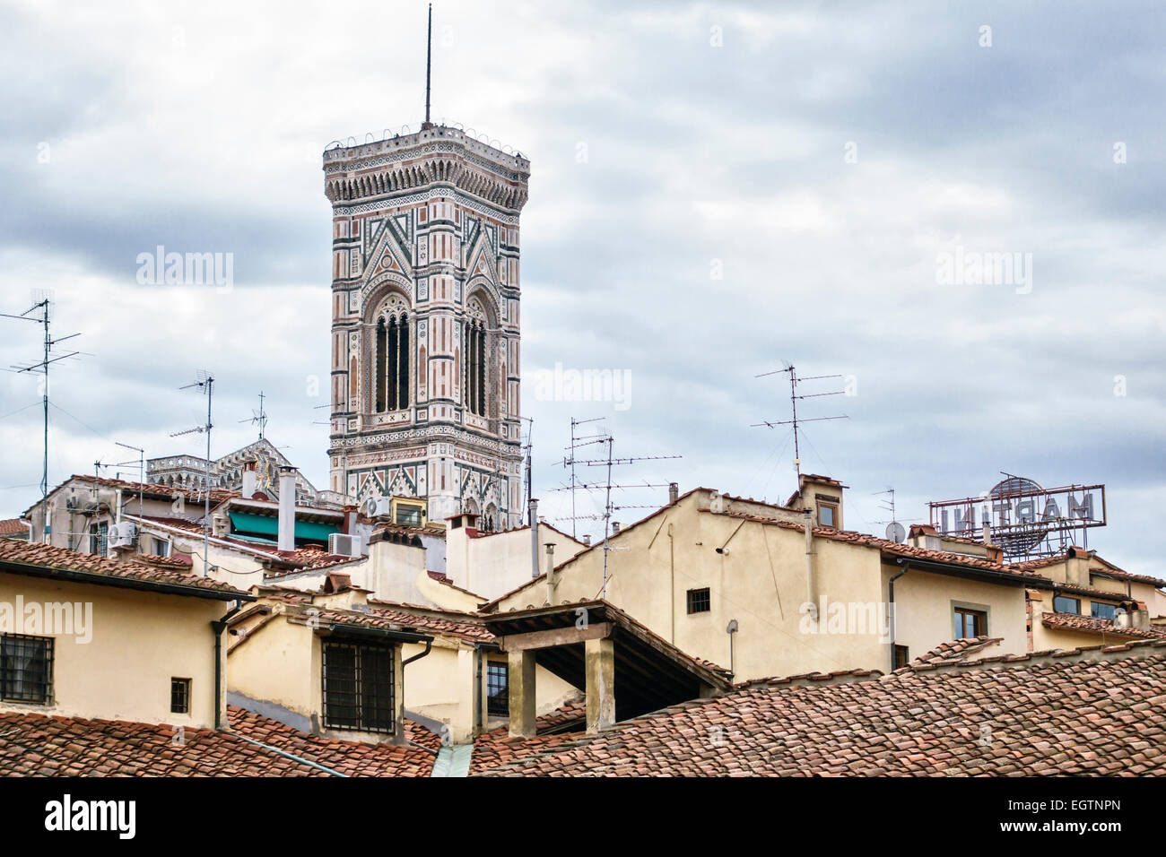 Giotto's Campanile, the bell tower of the Duomo (cathedral) of Florence, Italy, seen above the tiled roofs of the city, built between 1334-1359 Stock Photo