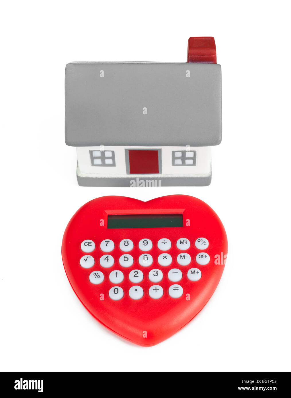 Calculator heart shaped and miniature house. Concept of purchase or mortgage. Stock Photo
