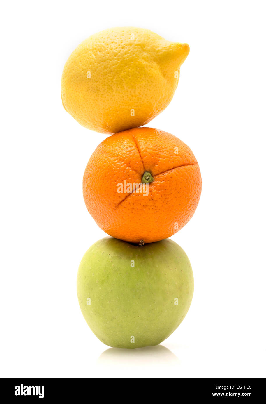 Apple, orange and lemon, stacked, with a white background. Stock Photo