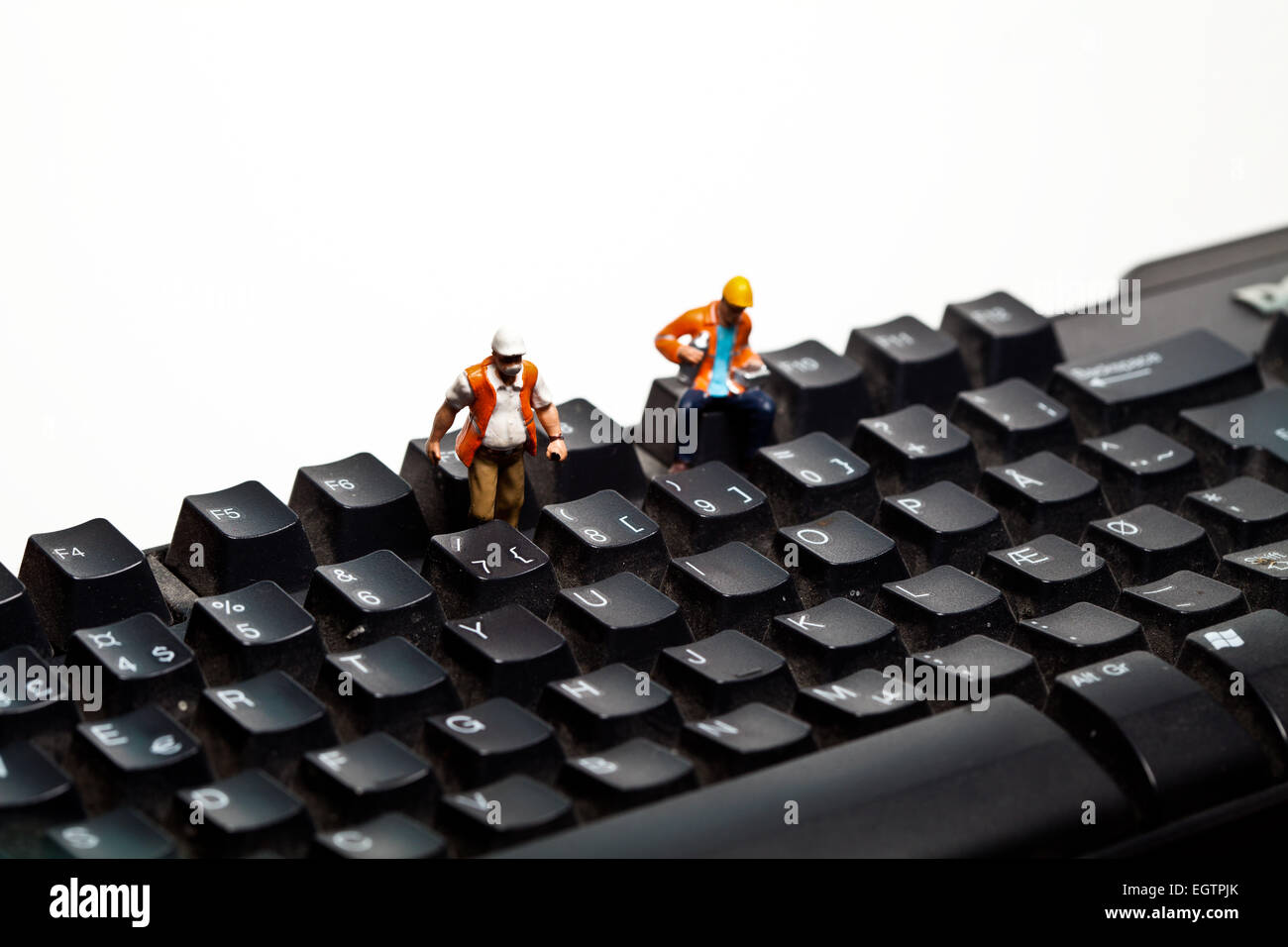 Miniature people in action on a computer keyborad Stock Photo - Alamy