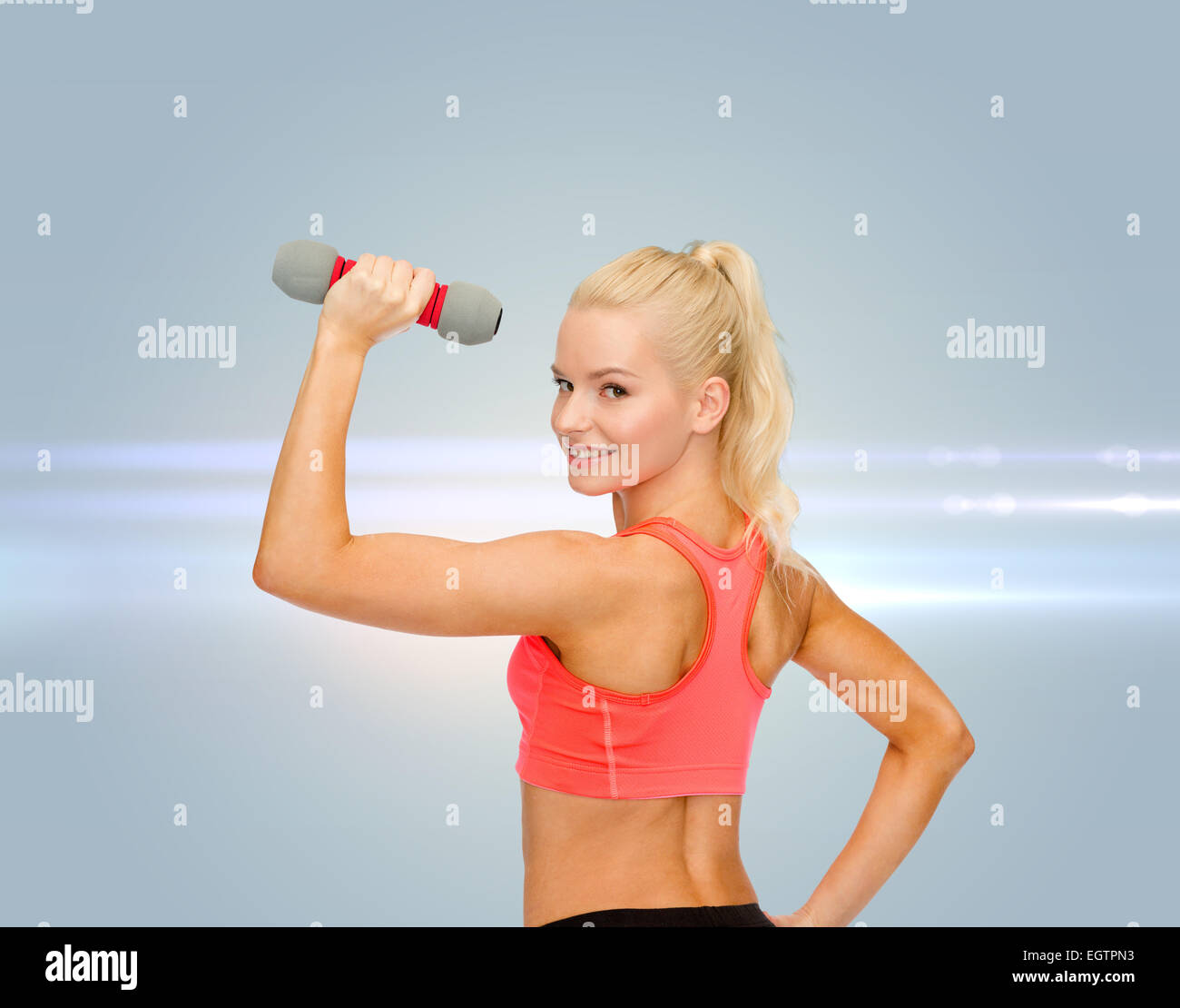 young sporty woman with light dumbbell Stock Photo