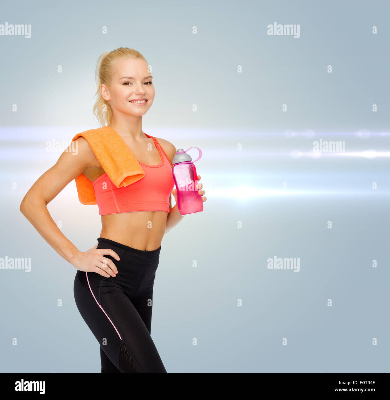 smiling sporty woman with water bottle and towel Stock Photo - Alamy