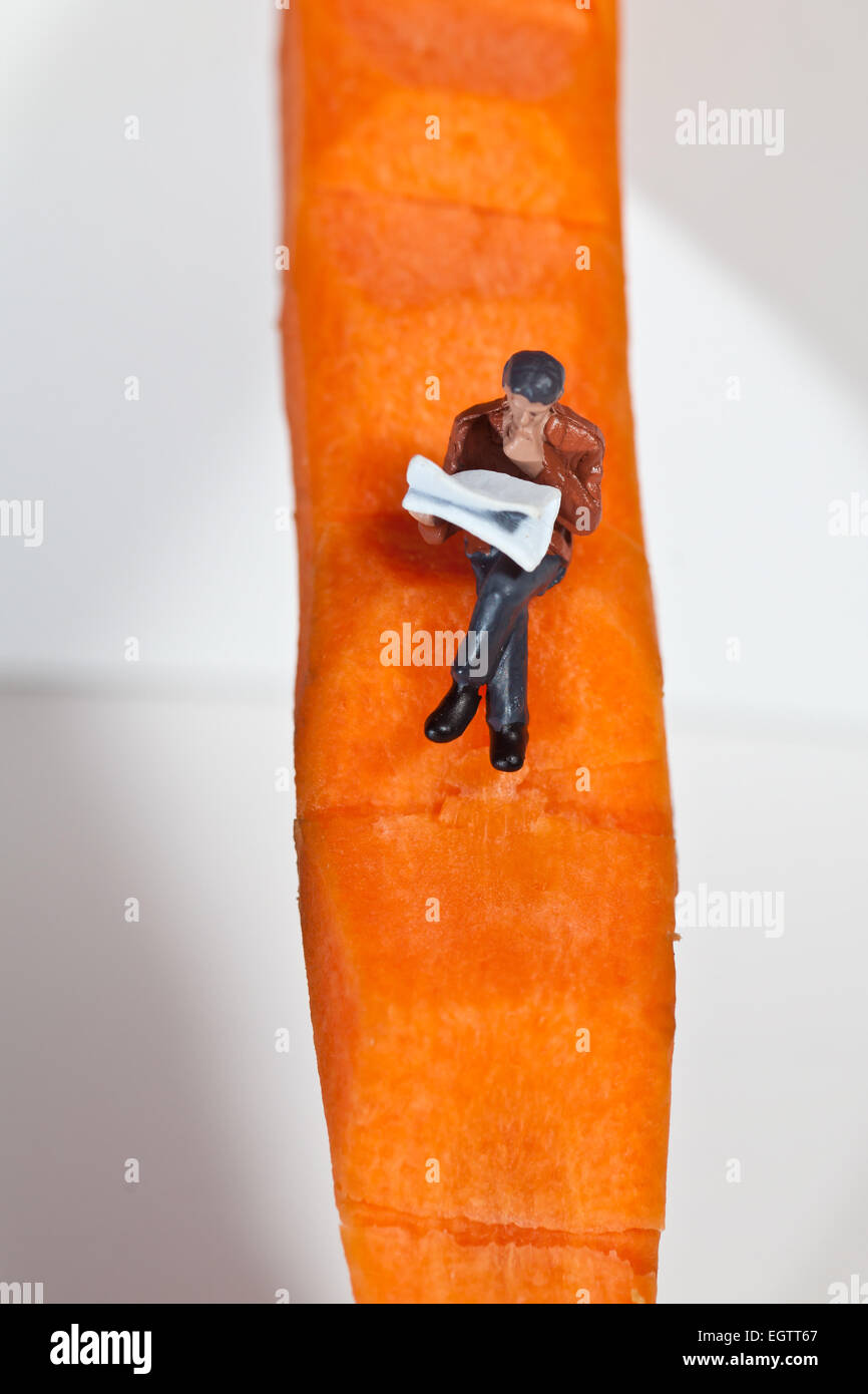 Miniature people in action in various situations Stock Photo