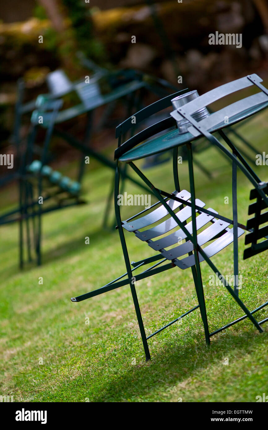 Table and chairs on grass in a park Stock Photo Alamy