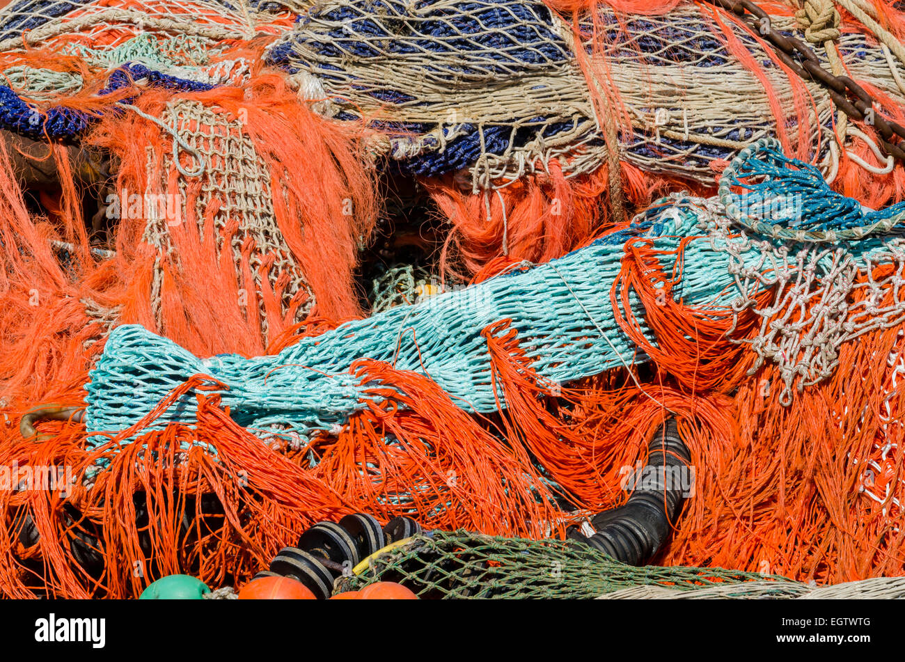 A pile of several colourful fishing nets and buoys in the harbour of Urk, The Netherlands. Stock Photo