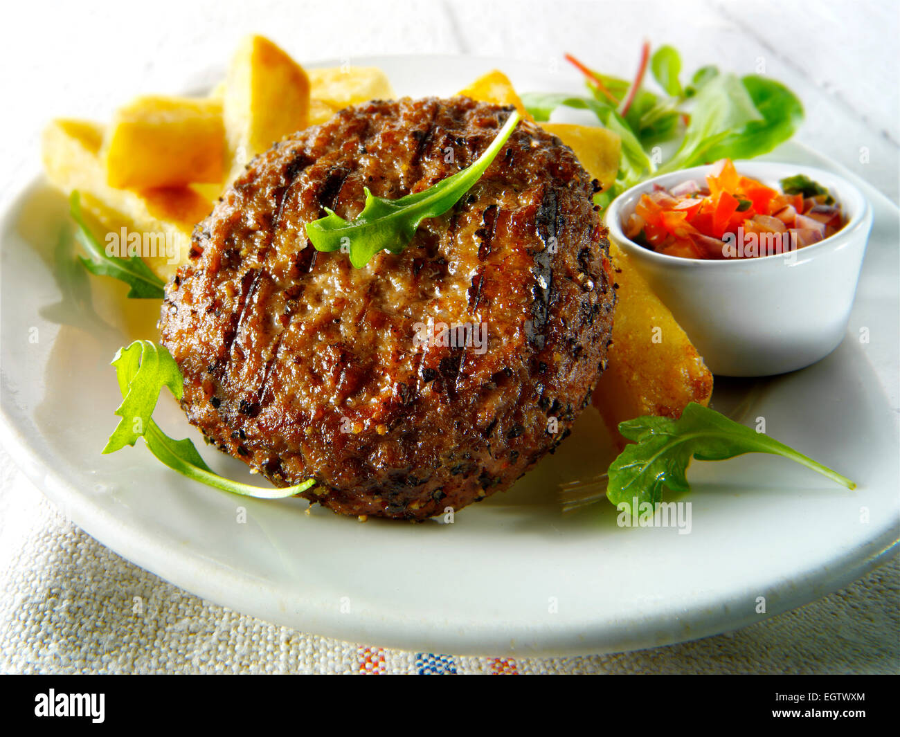 Char grilled beef burger with chunky chips, salad & relish Stock Photo Alamy