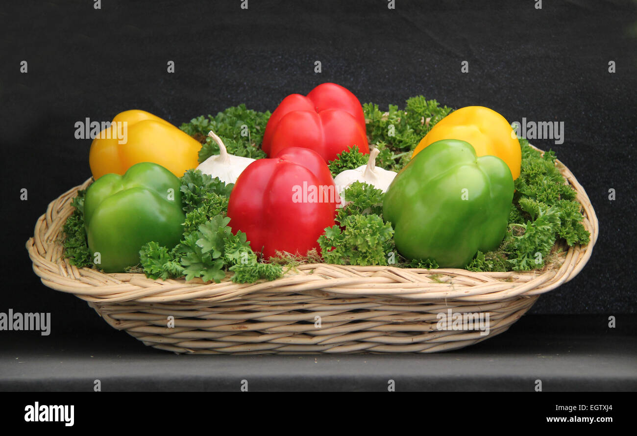 A Display of Peppers and Garlic on a Bed of Parsley. Stock Photo