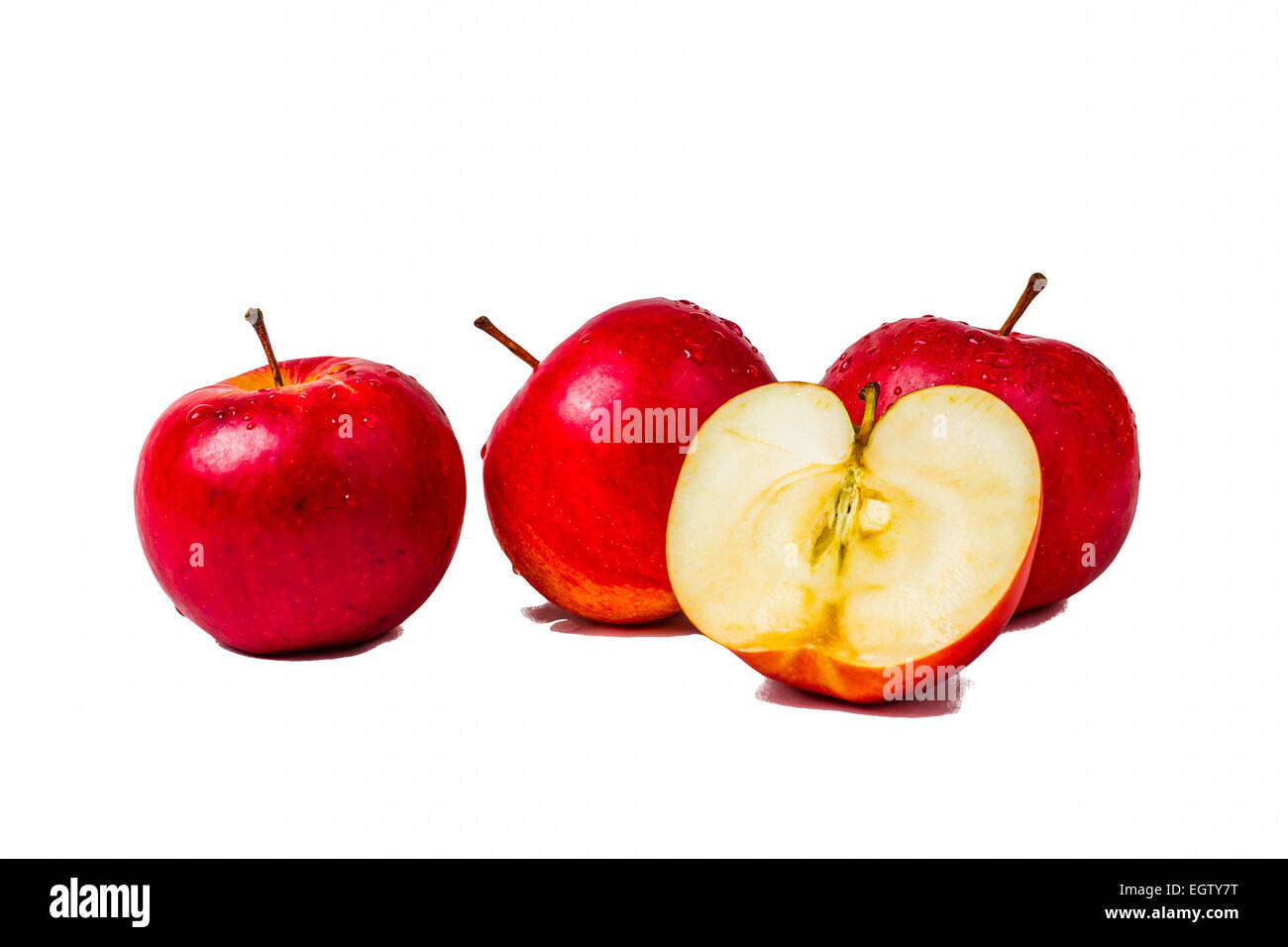 Three red apples and a half apple isolated against white background Stock Photo