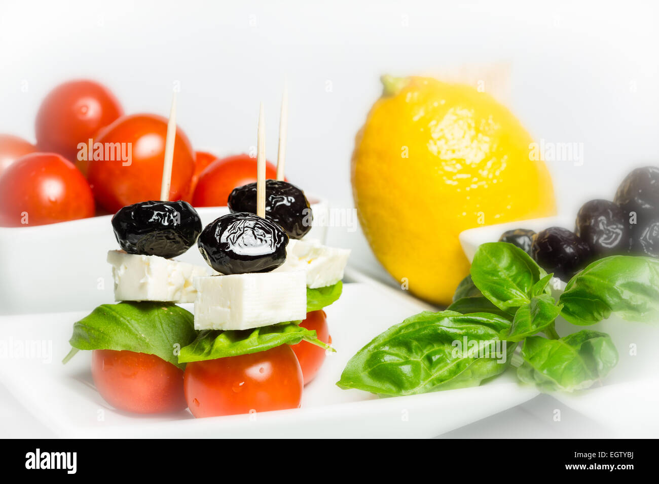 Italian style - tomato, cheese, olives and basil Stock Photo