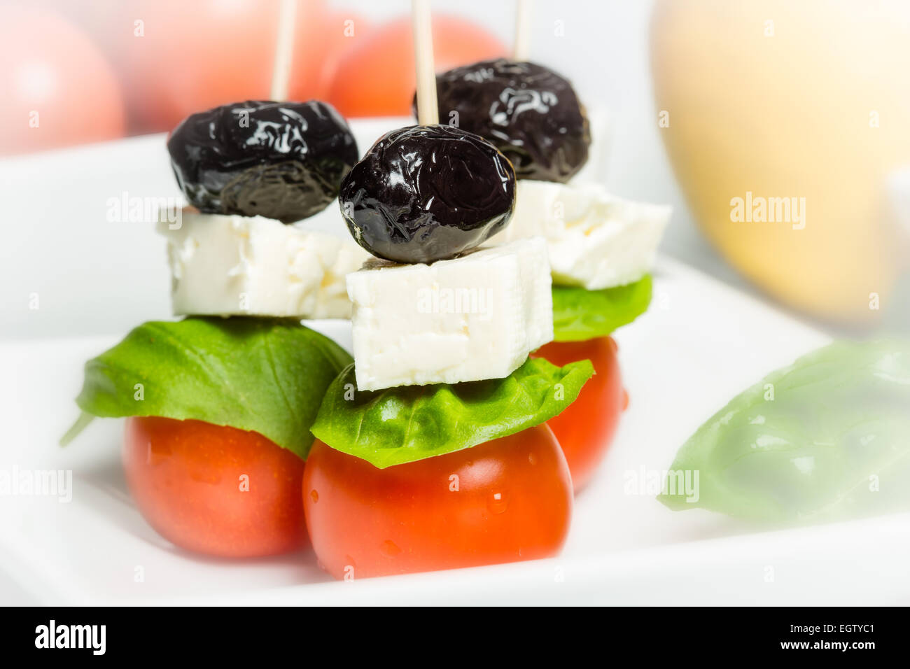 Italian style - tomato, cheese, olives and basil Stock Photo