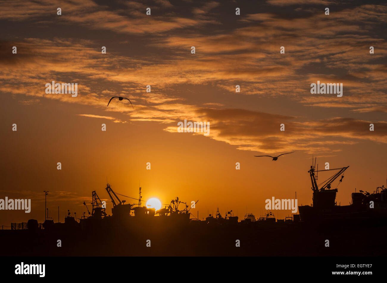 Hastings, East Sussex, UK. 2nd March, 2015. UK Weather: Sunset over the Old Town Fishing Fleet Stock Photo