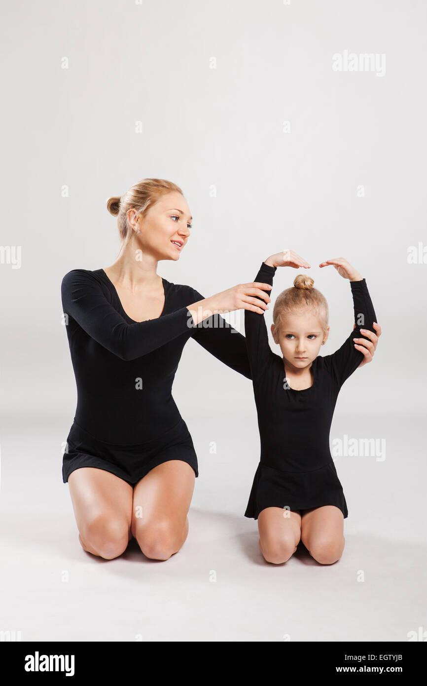 Mom teaching daughter gymnastics. Stock Photo
