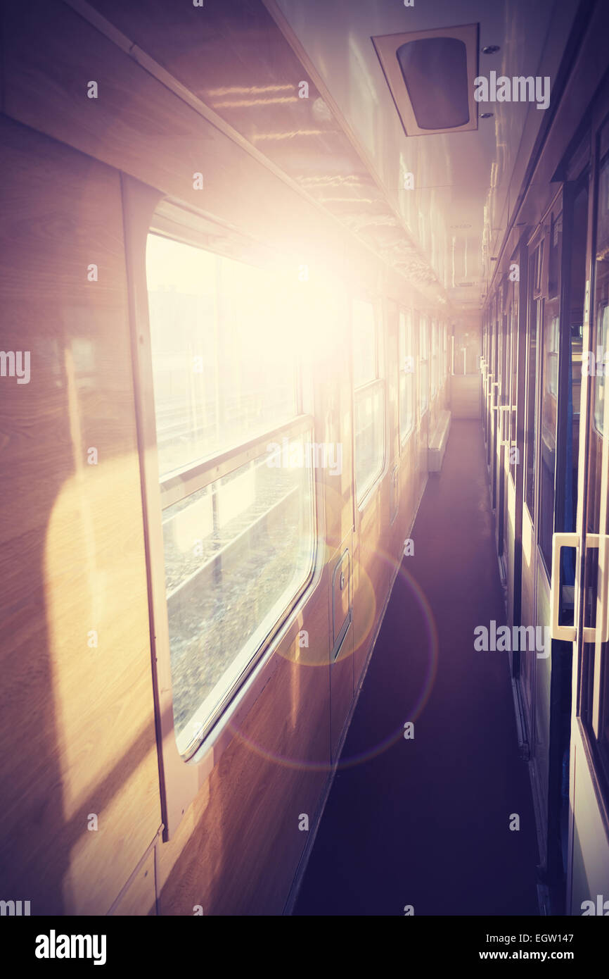 Retro filtered picture of a train coach interior with flare effect. Stock Photo