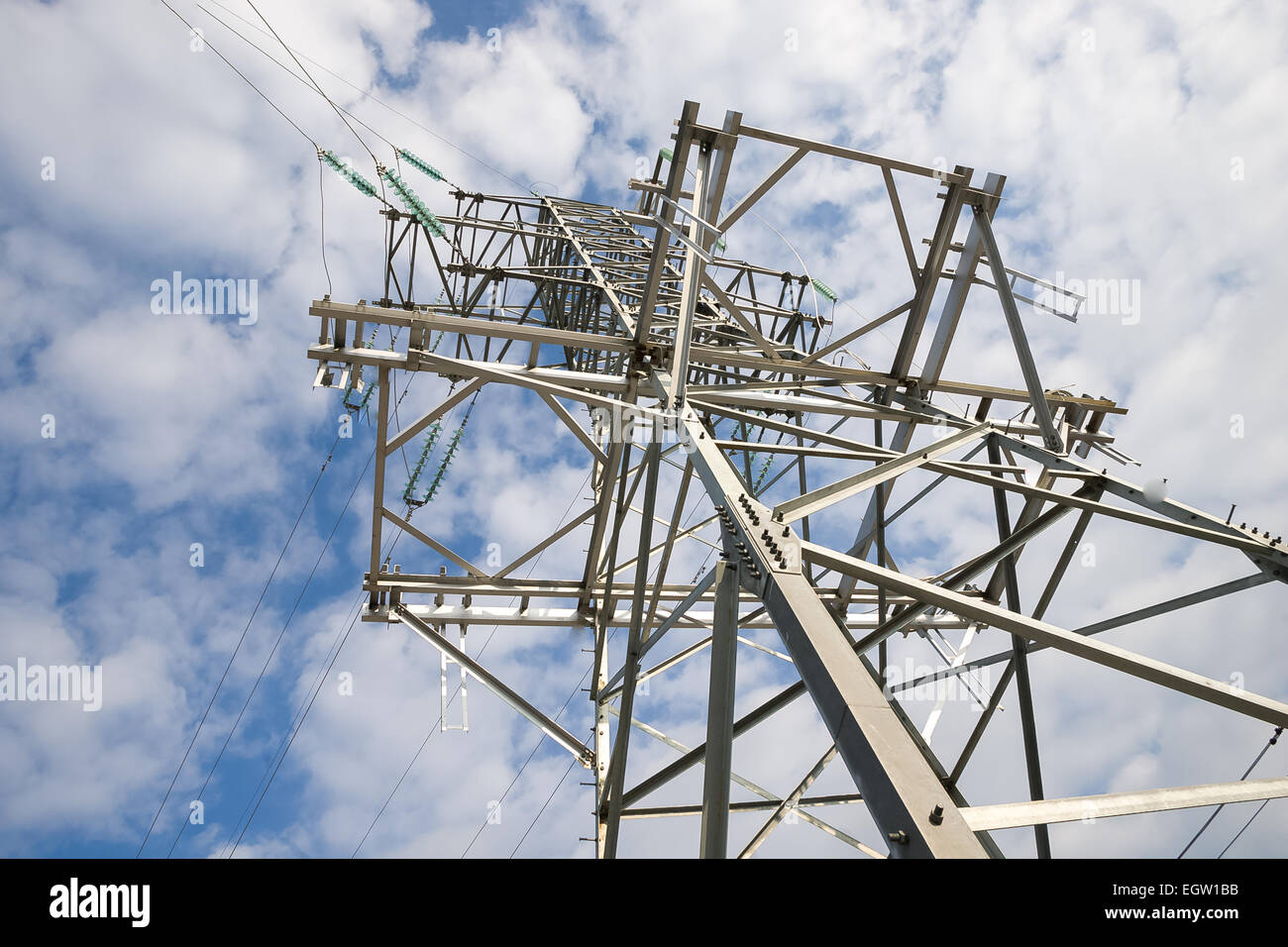 a high voltage power pylons against blue sky Stock Photo - Alamy
