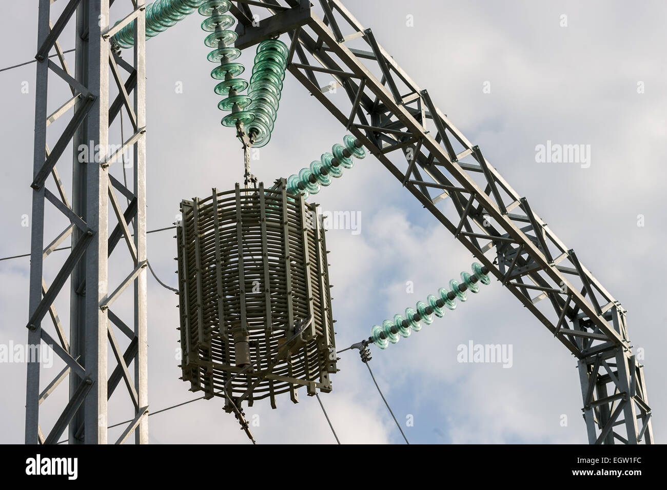 a high voltage power pylons against blue sky Stock Photo - Alamy