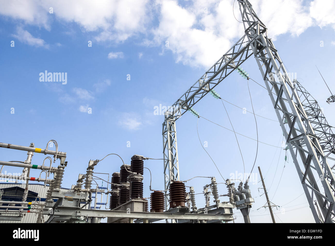 a high voltage power pylons against blue sky Stock Photo - Alamy