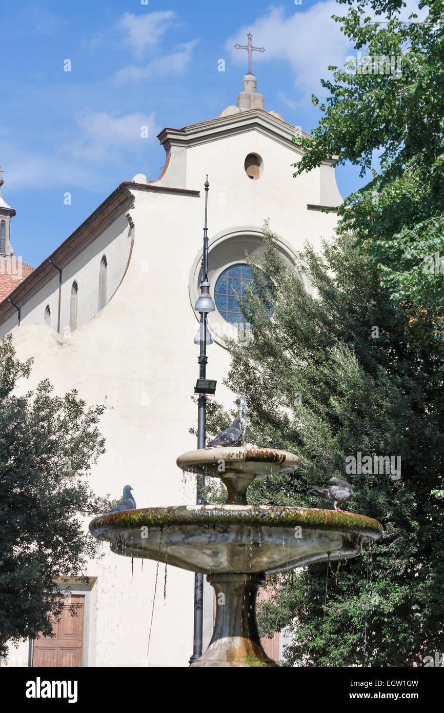 Small fountain in front of Basilica of the Holy Spirit facade in Florence, Italy Stock Photo